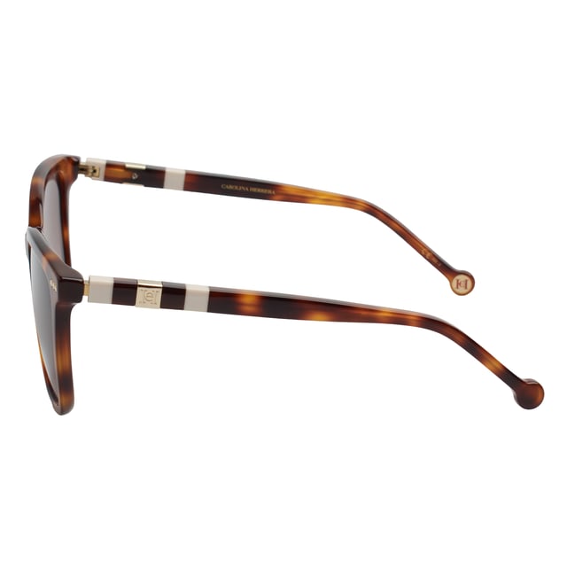 Designed with a wraparound silhouette and smooth lines, these Carolina Herrera sunglasses offer a refined interpretation of the classic square design, ideal for those seeking functional elegance and timeless style.

 Shape and design:
 - Softened square shape that adapts harmoniously to different face types.
 - Wide design provides superior visual coverage and a touch of sophistication at every angle.

 Frame material:
 - Made of high-quality acetate, durable and lightweight, ensuring a comfortable fit all day long.

 Brand details:
 - Carolina Herrera logo inscription on temples.

 Glasses:
 - Lenses with 100% UV protection filter, ideal for daily outdoor use.
 - Anti-reflective treatment that improves the visual experience and reduces glare.
 Measures: Lens width: 57 mm. Bridge: 18 mm. Temples: 145 mm
 Composition: Acetate
 Care:
Wash only with water or, if necessary, a mild soap.
 Dry with a soft cloth to avoid scratches.
 Avoid contact with harsh surfaces or abrasive liquids.