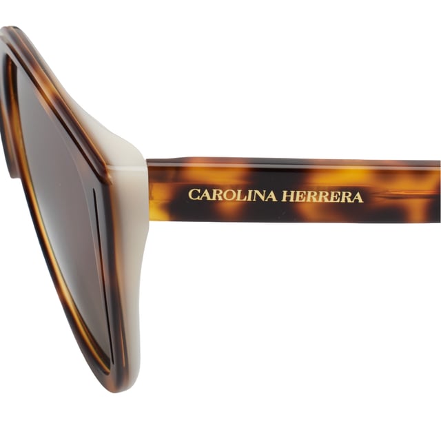 These Carolina Herrera sunglasses fuse elegant design with distinctive details that elevate any look with subtlety and sophistication. With a carefully crafted structure and refined finishes, they're the ideal accessory for those seeking style and protection with a distinct identity.

 Shape and design:
 - Soft cat-eye silhouette frame, ideal for enhancing features and adding a feminine touch with character.
 - Wraparound style that offers balanced visual coverage.

 Frame material:
 - High-quality acetate structure that provides strength and lightness.

 Brand details:
 - Carolina Herrera logo engraved on temples.
 - Rounded terminals with embossed CH metal logo, providing identity without excess.

 Glasses:
 - Lenses with 100% UV protection filter, ideal for daily outdoor use.
 Measures: Lens width: 53 mm. Bridge: 18 mm. Temples: 145 mm
 Composition: Acetate
 Care:
Wash only with water or, if necessary, a mild soap.
 Dry with a soft cloth to avoid scratches.
 Avoid contact with harsh surfaces or abrasive liquids.