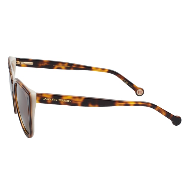 These Carolina Herrera sunglasses fuse elegant design with distinctive details that elevate any look with subtlety and sophistication. With a carefully crafted structure and refined finishes, they're the ideal accessory for those seeking style and protection with a distinct identity.

 Shape and design:
 - Soft cat-eye silhouette frame, ideal for enhancing features and adding a feminine touch with character.
 - Wraparound style that offers balanced visual coverage.

 Frame material:
 - High-quality acetate structure that provides strength and lightness.

 Brand details:
 - Carolina Herrera logo engraved on temples.
 - Rounded terminals with embossed CH metal logo, providing identity without excess.

 Glasses:
 - Lenses with 100% UV protection filter, ideal for daily outdoor use.
 Measures: Lens width: 53 mm. Bridge: 18 mm. Temples: 145 mm
 Composition: Acetate
 Care:
Wash only with water or, if necessary, a mild soap.
 Dry with a soft cloth to avoid scratches.
 Avoid contact with harsh surfaces or abrasive liquids.