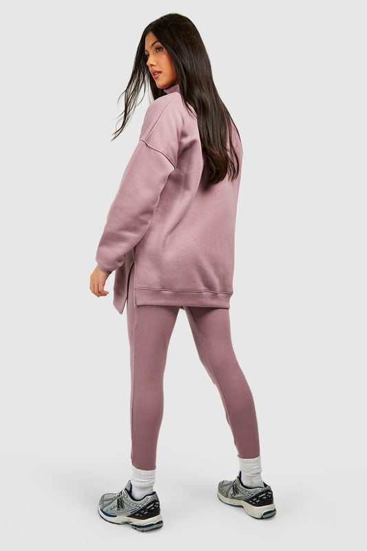Maternity-friendly oversized sweat top with half-zip design
        Comfortable rib leggings for growing bump
        Coordinated set for effortless style
        Practical front pocket on sweat top
        Versatile for various casual occasions
    
    Embrace comfort and style during your pregnancy with this chic maternity tracksuit set from Boohoo. The oversized sweat top features a trendy half-zip design, perfect for adjustable ventilation and easy nursing access. Paired with ribbed leggings that accommodate your growing bump, this set offers both flexibility and fashion-forward appeal. Style the top with the zip partially undone, revealing a contrasting layer underneath for added interest. For a laid-back weekend look, team with chunky trainers and a crossbody bag. Alternatively, dress it up for a casual lunch date by adding statement earrings and swapping trainers for stylish slip-on mules. This versatile set is ideal for family gatherings, relaxed outings with friends, or simply lounging at home in comfort and style.