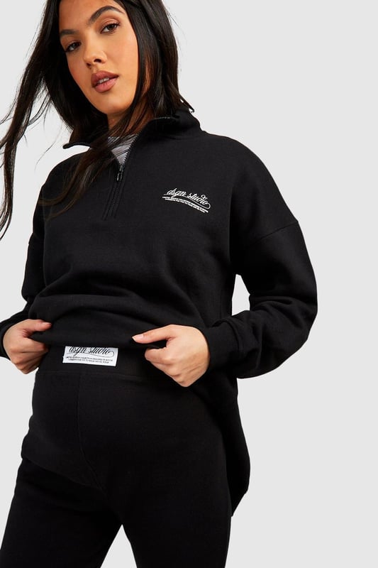 Maternity-friendly oversized sweat top with half-zip design
        Comfortable rib leggings for growing bump
        Coordinated set for effortless style
        Practical front pocket on sweat top
        Versatile for various casual occasions
    
    Embrace comfort and style during your pregnancy with this chic maternity tracksuit set from Boohoo. The oversized sweat top features a trendy half-zip design, perfect for adjustable ventilation and easy nursing access. Paired with ribbed leggings that accommodate your growing bump, this set offers both flexibility and fashion-forward appeal. Style the top with the zip partially undone, revealing a contrasting layer underneath for added interest. For a laid-back weekend look, team with chunky trainers and a crossbody bag. Alternatively, dress it up for a casual lunch date by adding statement earrings and swapping trainers for stylish slip-on mules. This versatile set is ideal for family gatherings, relaxed outings with friends, or simply lounging at home in comfort and style.