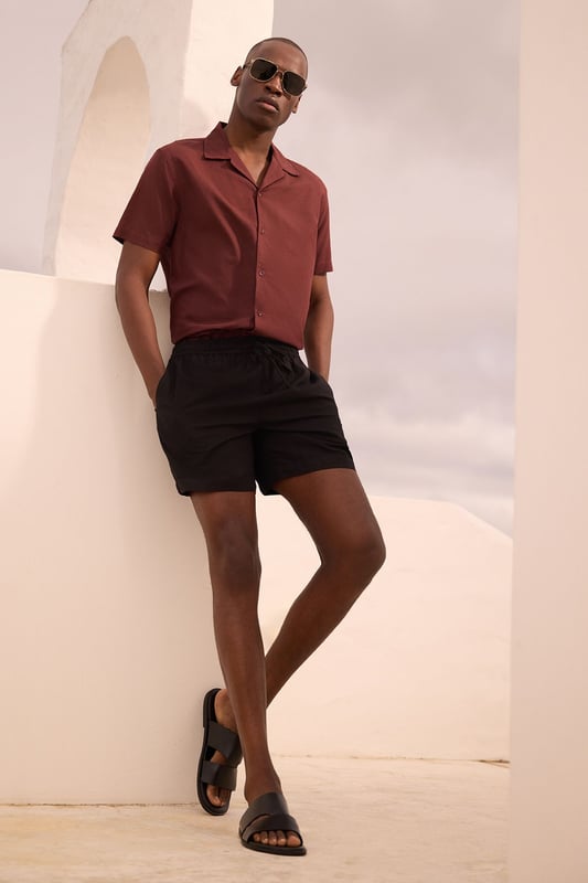 Resort-style shirt with classic camp collar design for a relaxed aesthetic
        Short sleeves with clean-finished edges for a neat, contemporary look
        Textured fabric blend featuring linen for breathability and comfort
        Straight hem with side splits allowing for versatile styling options
        Button-through front with tonal buttons for a sophisticated finish
    
    This Burton resort shirt combines casual comfort with effortless style, perfect for the modern man who appreciates classic design. The textured fabric offers a natural drape that looks equally impressive worn open over a plain t-shirt or buttoned up for a smarter appearance. Style with tailored shorts and leather sandals for warm-weather socialising, or pair with chino trousers and trainers for casual Friday at the office. The versatile design transitions seamlessly from daytime barbecues to evening drinks at your local, making it a wardrobe essential for the British summer. For cooler evenings, layer under a lightweight bomber jacket or unstructured blazer to maintain that relaxed yet put-together look that Burton is known for. Machine washable at 30 degrees, this shirt offers practicality alongside its undeniable style credentials.