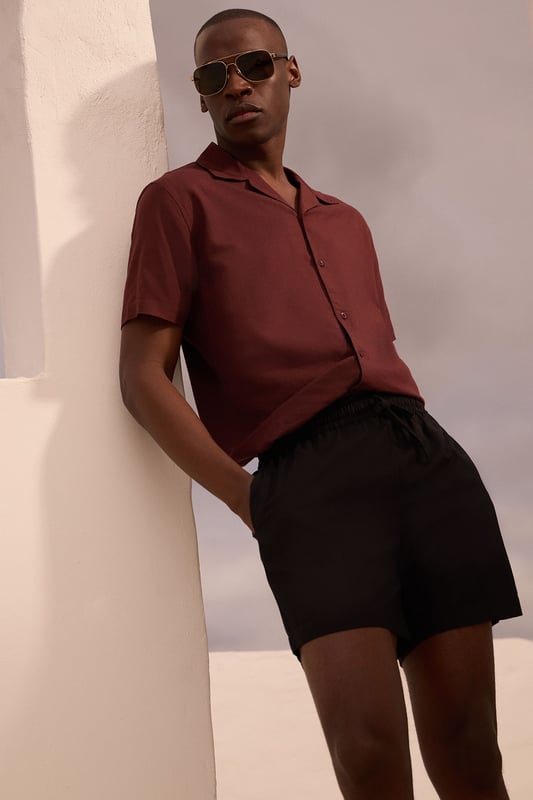 Resort-style shirt with classic camp collar design for a relaxed aesthetic
        Short sleeves with clean-finished edges for a neat, contemporary look
        Textured fabric blend featuring linen for breathability and comfort
        Straight hem with side splits allowing for versatile styling options
        Button-through front with tonal buttons for a sophisticated finish
    
    This Burton resort shirt combines casual comfort with effortless style, perfect for the modern man who appreciates classic design. The textured fabric offers a natural drape that looks equally impressive worn open over a plain t-shirt or buttoned up for a smarter appearance. Style with tailored shorts and leather sandals for warm-weather socialising, or pair with chino trousers and trainers for casual Friday at the office. The versatile design transitions seamlessly from daytime barbecues to evening drinks at your local, making it a wardrobe essential for the British summer. For cooler evenings, layer under a lightweight bomber jacket or unstructured blazer to maintain that relaxed yet put-together look that Burton is known for. Machine washable at 30 degrees, this shirt offers practicality alongside its undeniable style credentials.
