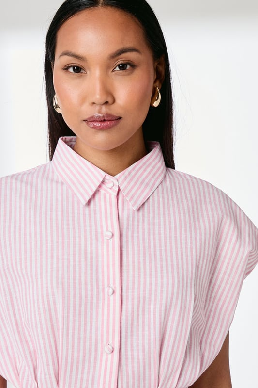 Elegant striped shirt with distinctive pleat detailing for a flattering silhouette
        Crafted from a cotton-linen blend for breathable comfort throughout the day
        Classic collared neckline with full button-through fastening
        Relaxed cap sleeves create a contemporary, effortless look
        Cinched waist pleats add structure and feminine shaping
    
    This Principles striped shirt combines timeless style with modern detailing, making it a versatile addition to your wardrobe. The structured pleats create a beautifully tailored effect at the waist, whilst the relaxed cap sleeves offer a contemporary twist on a classic design. Style with straight-leg jeans and leather sandals for casual weekend brunches, or tuck into tailored trousers with ballet flats for a polished office ensemble. The cotton-linen blend ensures this piece remains comfortable for all-day wear, whether you're running errands or meeting friends for coffee. Layer under a lightweight cardigan when the temperature drops, or wear open over a simple vest top for a more relaxed approach. This shirt works beautifully for family gatherings or casual daytime events where understated elegance is key.
