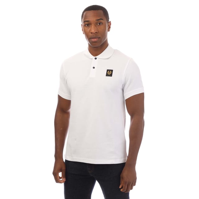 Mens Belstaff Cotton Piqué Polo Shirt in white.- Ribbed polo collar.- Two button placket.- Short sleeves with ribbed cuffs.- Embroidered Phoenix logo patch at left chest.- Uneven vented hem.- Textured cotton piqué made from organically grown cotton.- Regular fit.- Body: 100% Cotton.  Rib: 100% Cotton.  Machine washable.- Ref: 101516WHITE