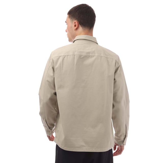 Mens Hugo Boss Lovel Zipped Overshirt in beige.- Classic collar.- Long sleeves.- Soft twill with embroidered branding on the pocket.- Branded button fastening cuffs.- Woven orange locker loop on the interior neckline.- Oversized fit.- 100% Cotton.- Ref: 50520107271