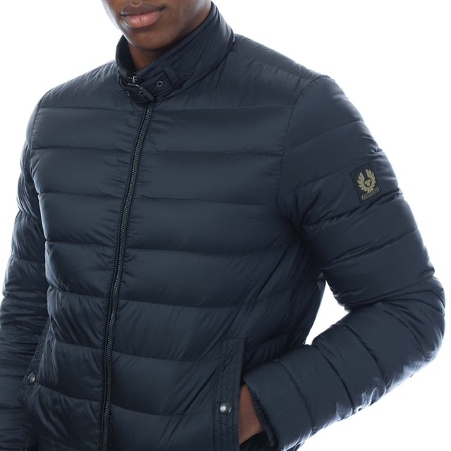 Mens Belstaff Circuit Jacket in dark ink.- Stand collar with adjustable throat latch.- Centre front zip closure.- Elasticated inner cuffs.- Rib at hem with racked stitch detailing.- Belstaff phoenix patch on left sleeve.- Two multi-stitch side pockets and one inside pocket with press-stud closures.- High-density  water-repellent nylon fabric.- High warmth to weight ratio.- Lightweight and compressible.- 750 fill power down.- 100% RDS certified down and feather.- Shell: 100% polyamide  Lining: 100% polyamide.  Filling: 90% white duck down  10% white duck feather.  Rib: 90% cotton  8% polyester  2% elastane.  Machine washable.- Ref: 105293DKINK