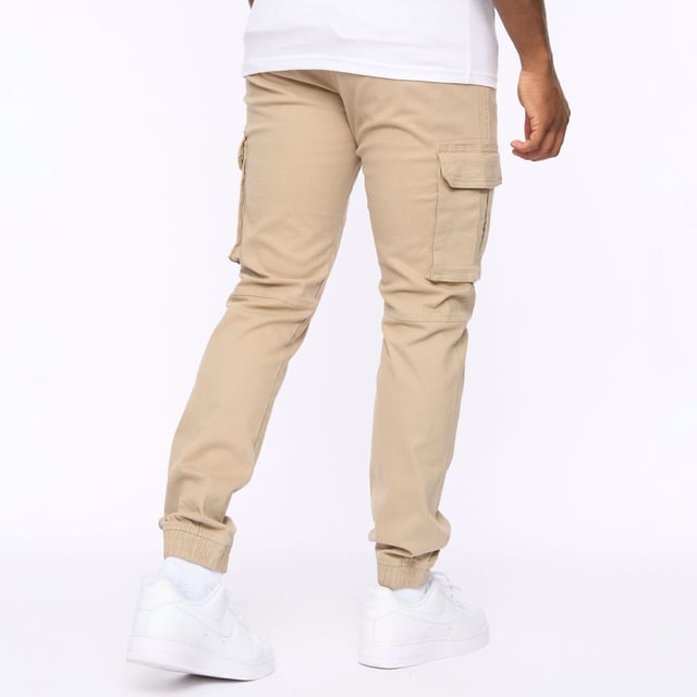 Presenting our men's straight cargo pants  featuring a top button fastening and scooped front pocket mouths for added convenience. These pants also include button-fastened cargo pockets and hidden button-fastened back pocket flaps for secure storage. Complete with a back waist leather patch.