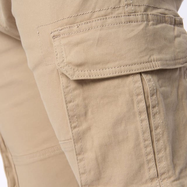 Presenting our men's straight cargo pants  featuring a top button fastening and scooped front pocket mouths for added convenience. These pants also include button-fastened cargo pockets and hidden button-fastened back pocket flaps for secure storage. Complete with a back waist leather patch.