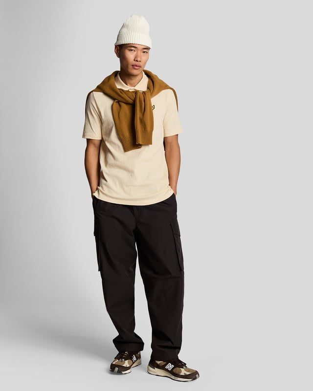 Introducing the Crepe Polo Shirt, a pinnacle of sophistication in our Spring menswear collection. This elegant piece features a refined relaxed fit and is crafted from a luxurious blend of 98% cotton and 2% elastane, ensuring ultimate comfort and mobility. Thoughtfully designed with a two-button placket and adorned with the distinctive Golden Eagle tab on the left chest, this polo exemplifies timeless style and versatility.

- Composition: 98% Cotton, 2% Elastane
- Fit: Relaxed
- Logo Branding: Golden Eagle tab
- Logo Placement: Left chest
- Versatile styling for casual and semi-formal occasions

Elevate your wardrobe with this sophisticated polo, perfect for the discerning gentleman this spring.
