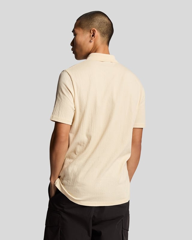 Introducing the Crepe Polo Shirt, a pinnacle of sophistication in our Spring menswear collection. This elegant piece features a refined relaxed fit and is crafted from a luxurious blend of 98% cotton and 2% elastane, ensuring ultimate comfort and mobility. Thoughtfully designed with a two-button placket and adorned with the distinctive Golden Eagle tab on the left chest, this polo exemplifies timeless style and versatility.

- Composition: 98% Cotton, 2% Elastane
- Fit: Relaxed
- Logo Branding: Golden Eagle tab
- Logo Placement: Left chest
- Versatile styling for casual and semi-formal occasions

Elevate your wardrobe with this sophisticated polo, perfect for the discerning gentleman this spring.