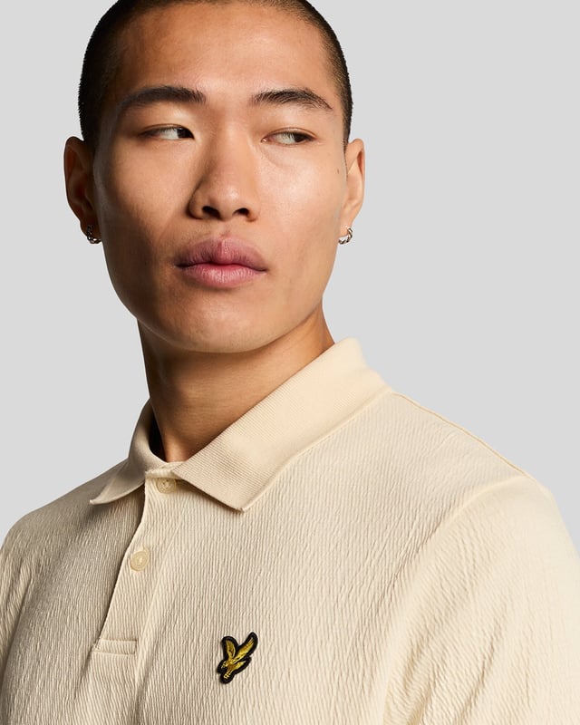 Introducing the Crepe Polo Shirt, a pinnacle of sophistication in our Spring menswear collection. This elegant piece features a refined relaxed fit and is crafted from a luxurious blend of 98% cotton and 2% elastane, ensuring ultimate comfort and mobility. Thoughtfully designed with a two-button placket and adorned with the distinctive Golden Eagle tab on the left chest, this polo exemplifies timeless style and versatility.

- Composition: 98% Cotton, 2% Elastane
- Fit: Relaxed
- Logo Branding: Golden Eagle tab
- Logo Placement: Left chest
- Versatile styling for casual and semi-formal occasions

Elevate your wardrobe with this sophisticated polo, perfect for the discerning gentleman this spring.
