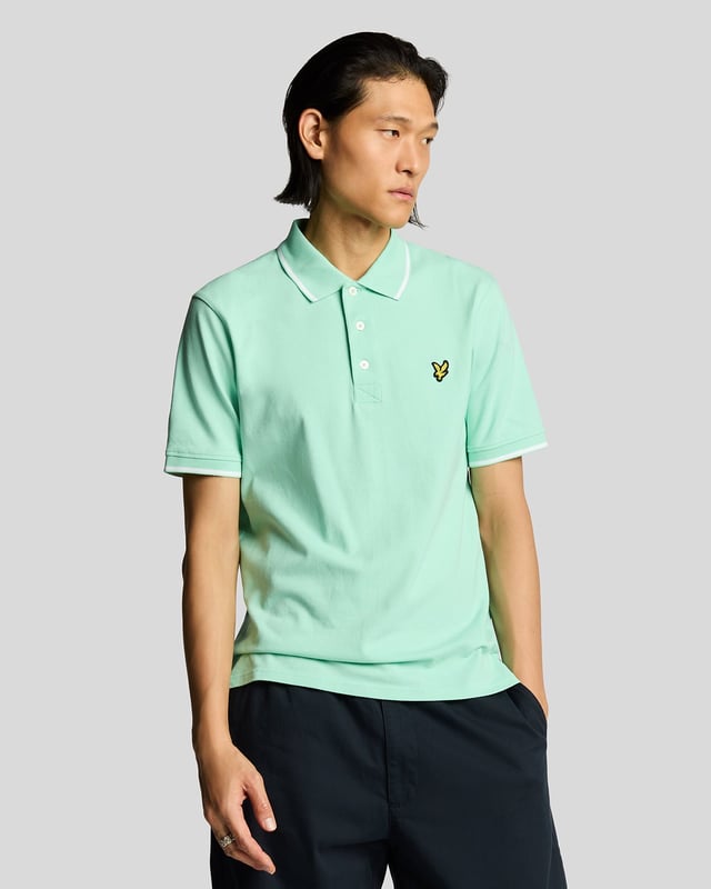 When people think of Lyle & Scott, they often think of polo shirts, so it stands to reason that we create the best polo shirts season after season. This one is cut for a classic fit in cotton jersey with a bit of added stretch and is finished with contrast tipping at the collar and cuffs for a slightly preppy look. - Classic collar 
- Front button fastening 
- Short sleeves 
- Tipped collar and cuffs
- Composition: 97% cotton, 3% elastane