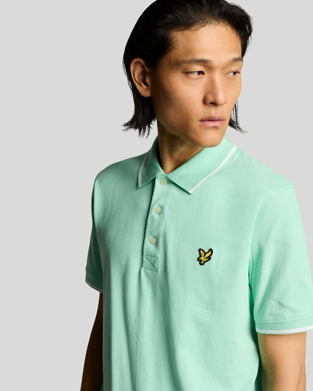 When people think of Lyle & Scott, they often think of polo shirts, so it stands to reason that we create the best polo shirts season after season. This one is cut for a classic fit in cotton jersey with a bit of added stretch and is finished with contrast tipping at the collar and cuffs for a slightly preppy look. - Classic collar 
- Front button fastening 
- Short sleeves 
- Tipped collar and cuffs
- Composition: 97% cotton, 3% elastane