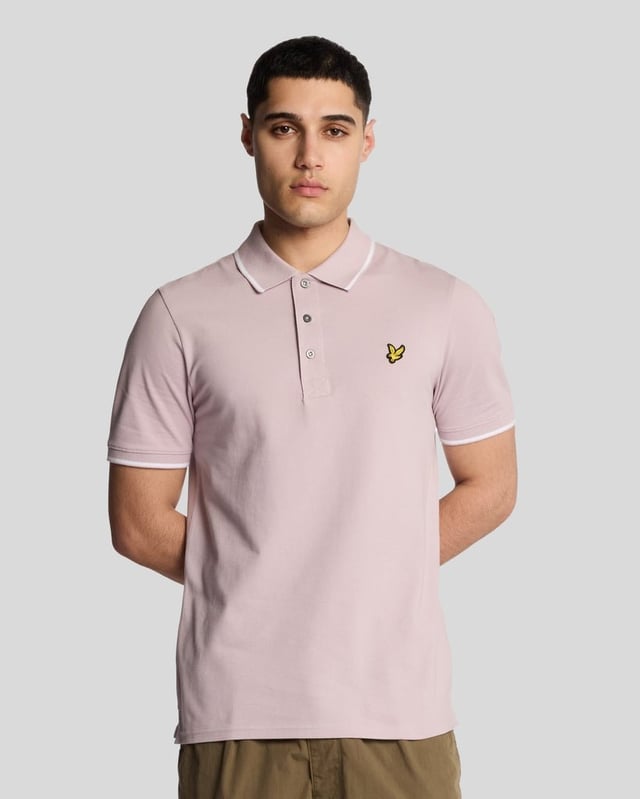 When people think of Lyle & Scott, they often think of polo shirts, so it stands to reason that we create the best polo shirts season after season. This one is cut for a classic fit in cotton jersey with a bit of added stretch and is finished with contrast tipping at the collar and cuffs for a slightly preppy look. - Classic collar 
- Front button fastening 
- Short sleeves 
- Tipped collar and cuffs
- Composition: 97% cotton, 3% elastane