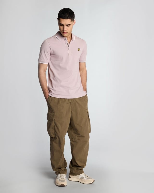 When people think of Lyle & Scott, they often think of polo shirts, so it stands to reason that we create the best polo shirts season after season. This one is cut for a classic fit in cotton jersey with a bit of added stretch and is finished with contrast tipping at the collar and cuffs for a slightly preppy look. - Classic collar 
- Front button fastening 
- Short sleeves 
- Tipped collar and cuffs
- Composition: 97% cotton, 3% elastane