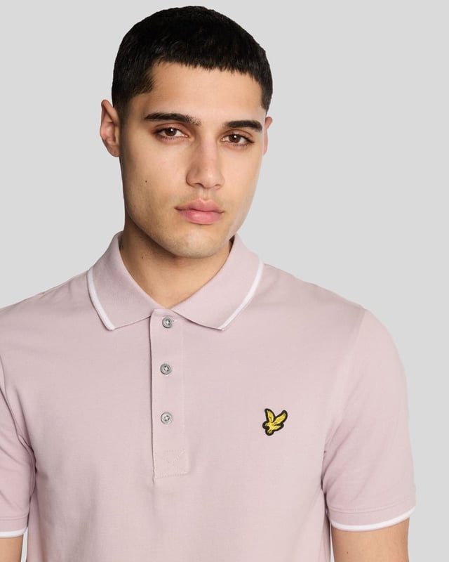 When people think of Lyle & Scott, they often think of polo shirts, so it stands to reason that we create the best polo shirts season after season. This one is cut for a classic fit in cotton jersey with a bit of added stretch and is finished with contrast tipping at the collar and cuffs for a slightly preppy look. - Classic collar 
- Front button fastening 
- Short sleeves 
- Tipped collar and cuffs
- Composition: 97% cotton, 3% elastane