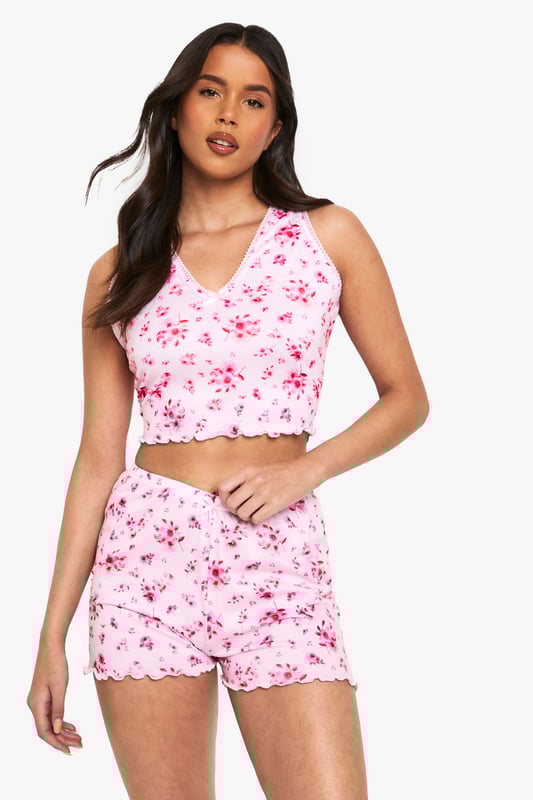Charming floral print pyjama set
        Delicate lace trim detailing
        Sleeveless crop top with V-neckline
        Matching shorts with scalloped hem
        Comfortable and stylish two-piece design
    
    Drift off to dreamland in style with this enchanting floral pyjama set from Boohoo. The sleeveless crop top features a flattering V-neckline adorned with delicate lace trim, while the matching shorts boast a charming scalloped hem. Perfect for warm summer nights or cosy evenings in, this set combines comfort with a touch of feminine flair. Layer with a soft dressing gown for those chilly mornings, or pair the top with your favourite lounge trousers for a mix-and-match look. Whether you're having a pamper night in or a girly sleepover, this versatile set will ensure you look and feel fabulous even as you slumber.