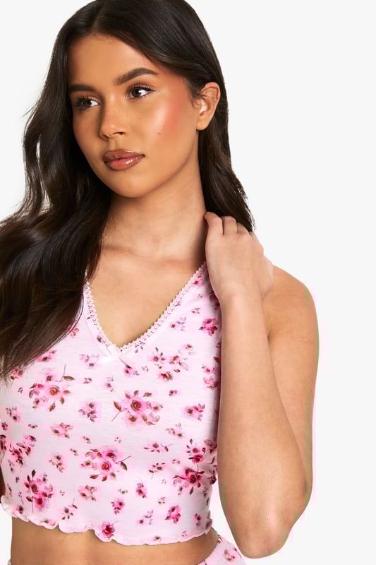 Charming floral print pyjama set
        Delicate lace trim detailing
        Sleeveless crop top with V-neckline
        Matching shorts with scalloped hem
        Comfortable and stylish two-piece design
    
    Drift off to dreamland in style with this enchanting floral pyjama set from Boohoo. The sleeveless crop top features a flattering V-neckline adorned with delicate lace trim, while the matching shorts boast a charming scalloped hem. Perfect for warm summer nights or cosy evenings in, this set combines comfort with a touch of feminine flair. Layer with a soft dressing gown for those chilly mornings, or pair the top with your favourite lounge trousers for a mix-and-match look. Whether you're having a pamper night in or a girly sleepover, this versatile set will ensure you look and feel fabulous even as you slumber.