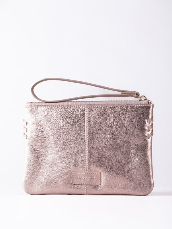 Compact, stylish, and effortlessly functional, the Tarnly purse pouch is designed for everyday ease. Crafted from supple leather, it features a refined front logo emboss and whipstitch detailing along the sides for a touch of artisanal charm. The zip-top closure is finished with a sleek leather wrist strap, making it perfect for carrying solo or slipping into a larger bag. Inside, a satin-lined interior offers thoughtful organisation with a slip pocket and three card slots, while built-in RFID protection keeps your essentials secure.&nbsp;