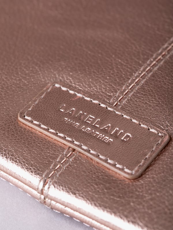 Compact, stylish, and effortlessly functional, the Tarnly purse pouch is designed for everyday ease. Crafted from supple leather, it features a refined front logo emboss and whipstitch detailing along the sides for a touch of artisanal charm. The zip-top closure is finished with a sleek leather wrist strap, making it perfect for carrying solo or slipping into a larger bag. Inside, a satin-lined interior offers thoughtful organisation with a slip pocket and three card slots, while built-in RFID protection keeps your essentials secure.&nbsp;