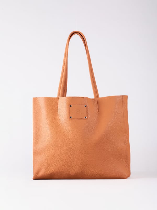 For relaxed leather luxury, look no further than the Tarn Bucket Bag in fresh apricot. This spacious tote style bag will effortlessly take you through the working week into the weekend with plenty of room for a laptop and notebooks or shopping if you&rsquo;re hitting the high street.
Crafted from real leather in a contemporary slouchy design, this bucket bag is fitted with a popper fastened top and conceals a handy inner cloth bag with zip top opening to keep your valuables extra safe. This cloth bag is securely clipped to a leather strap and is removable for ultimate versatility.