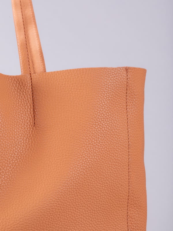 For relaxed leather luxury, look no further than the Tarn Bucket Bag in fresh apricot. This spacious tote style bag will effortlessly take you through the working week into the weekend with plenty of room for a laptop and notebooks or shopping if you&rsquo;re hitting the high street.
Crafted from real leather in a contemporary slouchy design, this bucket bag is fitted with a popper fastened top and conceals a handy inner cloth bag with zip top opening to keep your valuables extra safe. This cloth bag is securely clipped to a leather strap and is removable for ultimate versatility.