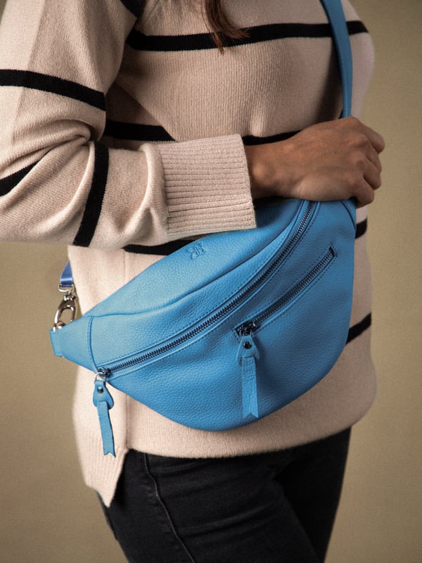 The Tarn Leather Sling Bag is a compact versatile style crafted from textured leather, designed for on-the-go. Boasting exterior zipped pockets as well as a main zipped compartment, there&rsquo;s plenty of places to organise your small essentials. The D-ring attachment on the comfy adjustable canvas strap allows you to easily wear this as a belt bag or cross body bag as you prefer. Adventure in style!