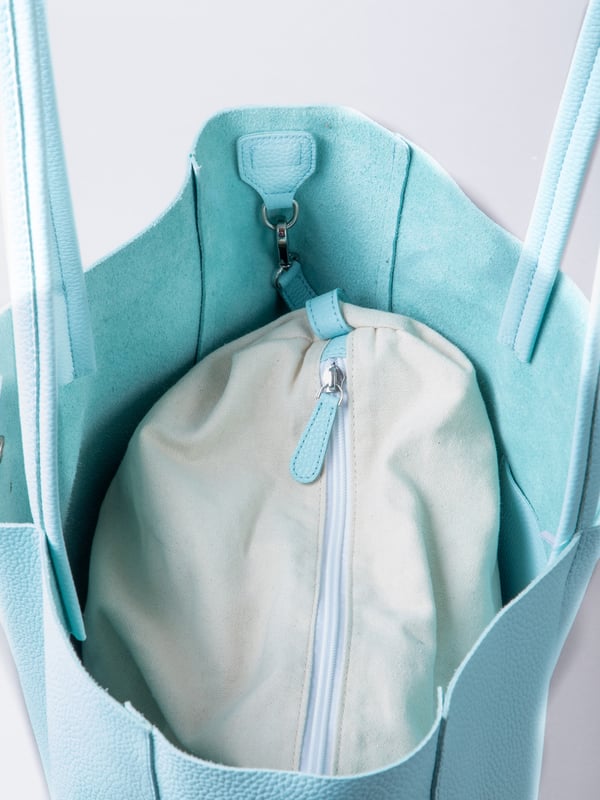 For relaxed leather luxury, look no further than the Tarn Bucket Bag in pretty turquoise. This spacious tote style bag will effortlessly take you through the working week into the weekend with plenty of room for a laptop and notebooks or shopping if you&rsquo;re hitting the high street.
Crafted from real leather in a contemporary slouchy design, this bucket bag is fitted with a popper fastened top and conceals a handy inner cloth bag with zip top opening to keep your valuables extra safe. This cloth bag is securely clipped to a leather strap and is removable for ultimate versatility.