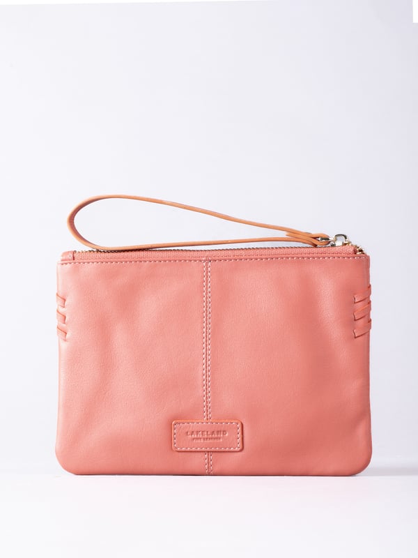 Compact, stylish, and effortlessly functional, the Tarnly purse pouch is designed for everyday ease. Crafted from supple leather, it features a refined front logo emboss and whipstitch detailing along the sides for a touch of artisanal charm. The zip-top closure is finished with a sleek leather wrist strap, making it perfect for carrying solo or slipping into a larger bag. Inside, a satin-lined interior offers thoughtful organisation with a slip pocket and three card slots, while built-in RFID protection keeps your essentials secure.&nbsp;