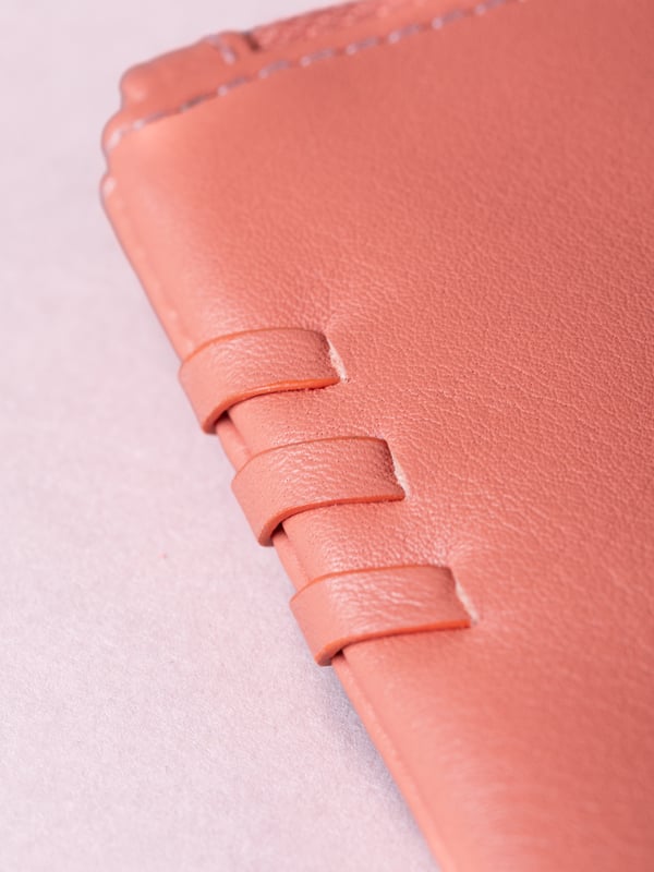 Compact, stylish, and effortlessly functional, the Tarnly purse pouch is designed for everyday ease. Crafted from supple leather, it features a refined front logo emboss and whipstitch detailing along the sides for a touch of artisanal charm. The zip-top closure is finished with a sleek leather wrist strap, making it perfect for carrying solo or slipping into a larger bag. Inside, a satin-lined interior offers thoughtful organisation with a slip pocket and three card slots, while built-in RFID protection keeps your essentials secure.&nbsp;