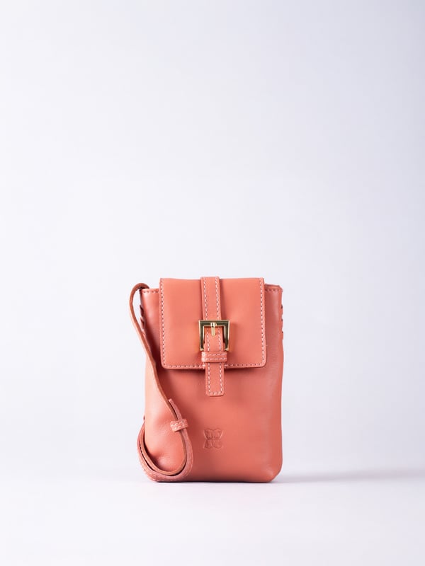 Small in size, big on style - the Tarnly phone pouch is the perfect hands-free companion for life on the move. Crafted from real leather with a soft satin lining, this compact cross-body features a flapover design secured with a magnetic press-stud fastening and finished with a decorative front buckle detail. Side stitch accents add a subtle crafted touch, while a rear zip pocket offers easy access to essentials. With an adjustable strap for the perfect fit, Tarnly keeps your phone and small valuables close in effortless style.