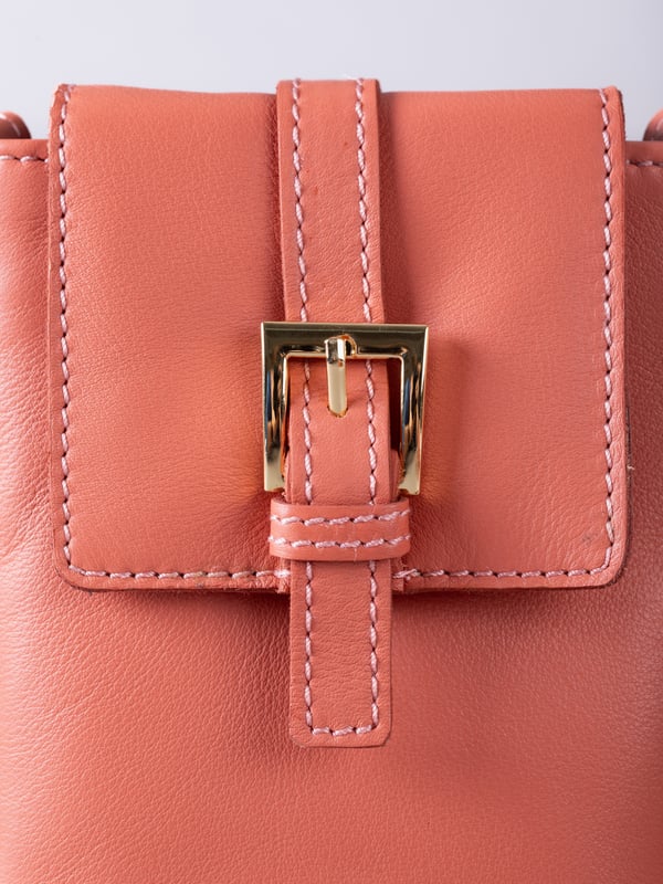 Small in size, big on style - the Tarnly phone pouch is the perfect hands-free companion for life on the move. Crafted from real leather with a soft satin lining, this compact cross-body features a flapover design secured with a magnetic press-stud fastening and finished with a decorative front buckle detail. Side stitch accents add a subtle crafted touch, while a rear zip pocket offers easy access to essentials. With an adjustable strap for the perfect fit, Tarnly keeps your phone and small valuables close in effortless style.