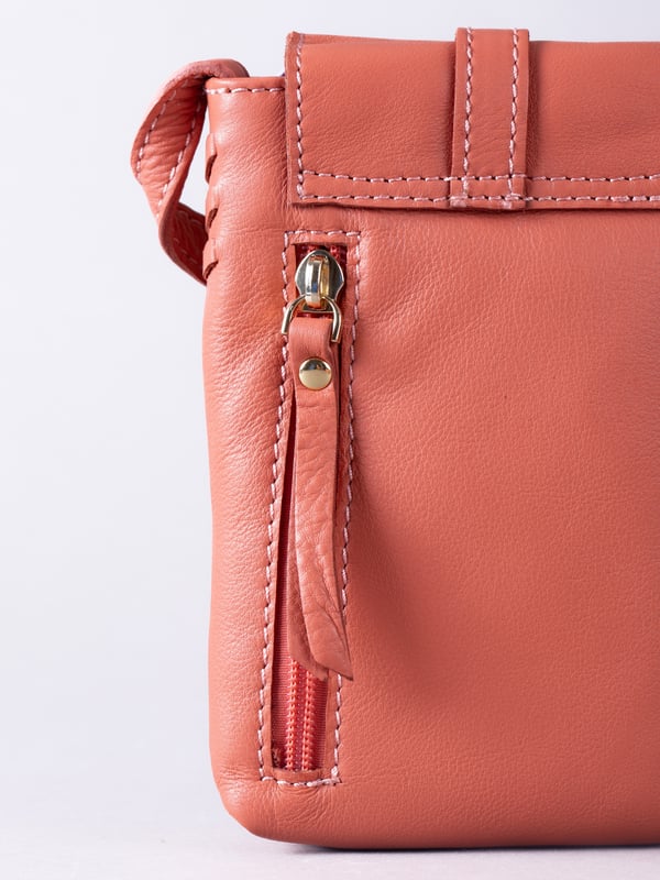 Small in size, big on style - the Tarnly phone pouch is the perfect hands-free companion for life on the move. Crafted from real leather with a soft satin lining, this compact cross-body features a flapover design secured with a magnetic press-stud fastening and finished with a decorative front buckle detail. Side stitch accents add a subtle crafted touch, while a rear zip pocket offers easy access to essentials. With an adjustable strap for the perfect fit, Tarnly keeps your phone and small valuables close in effortless style.
