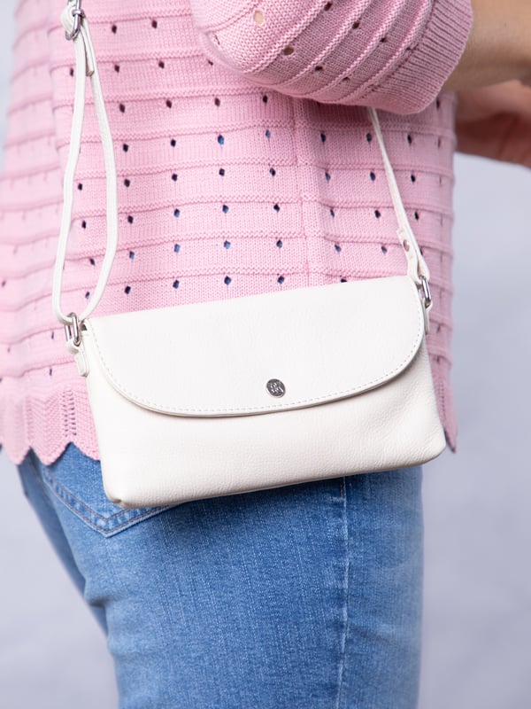 Streamlined, stylish, and just the right size, the Tawns bag is your go-to for those essentials you can&rsquo;t leave home without.
Compact yet practical, this mini cross-body bag is perfectly sized for your phone, keys, and other small must-haves. Crafted from real leather for a touch of understated luxury, it features a secure flapover press-stud fastening and an adjustable strap for the perfect fit.
With a soft fabric lining to protect your items, the Tawns is as functional as it is effortlessly chic.