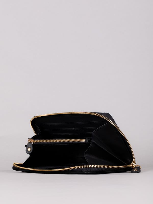 This large purse with handy zip around fastening is a must-have handbag accessory this season and beyond. Crafted from smooth leather, this purse contains ample storage for all your spending essentials including plenty of card slots, slip pockets and a zipped coin pocket. Finished with RFID protection to keep your cards electronically secure.