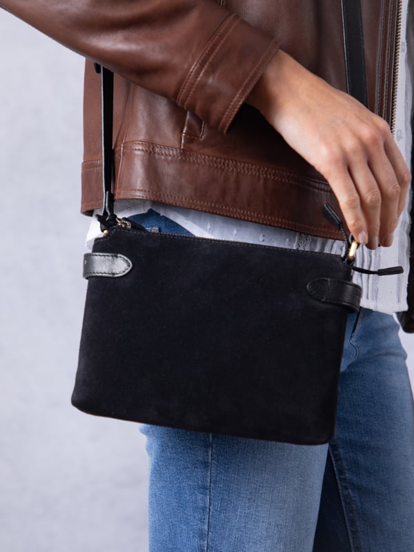 The Bridge twin cross body bag combines timeless style with practical design, making it a must-have for any wardrobe. Expertly crafted from real leather and suede, this versatile bag features a striking front suede compartment for added texture and interest. It also features an adjustable cross-body strap, offering a comfortable and customizable fit for hands-free wear.
With twin zip compartments &mdash; one smooth leather and one soft suede &mdash; there&rsquo;s ample space to keep essentials organized, while the interior slip pocket ensures smaller items stay secure. Finished with a ribbed fabric lining and available in three elegant colours, the Bridge bag is your go-to accessory for refined everyday style.