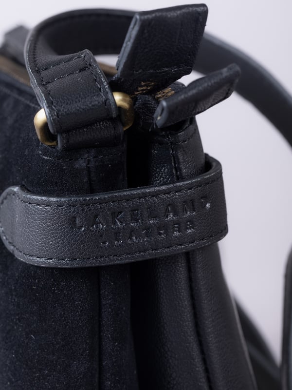 The Bridge twin cross body bag combines timeless style with practical design, making it a must-have for any wardrobe. Expertly crafted from real leather and suede, this versatile bag features a striking front suede compartment for added texture and interest. It also features an adjustable cross-body strap, offering a comfortable and customizable fit for hands-free wear.
With twin zip compartments &mdash; one smooth leather and one soft suede &mdash; there&rsquo;s ample space to keep essentials organized, while the interior slip pocket ensures smaller items stay secure. Finished with a ribbed fabric lining and available in three elegant colours, the Bridge bag is your go-to accessory for refined everyday style.