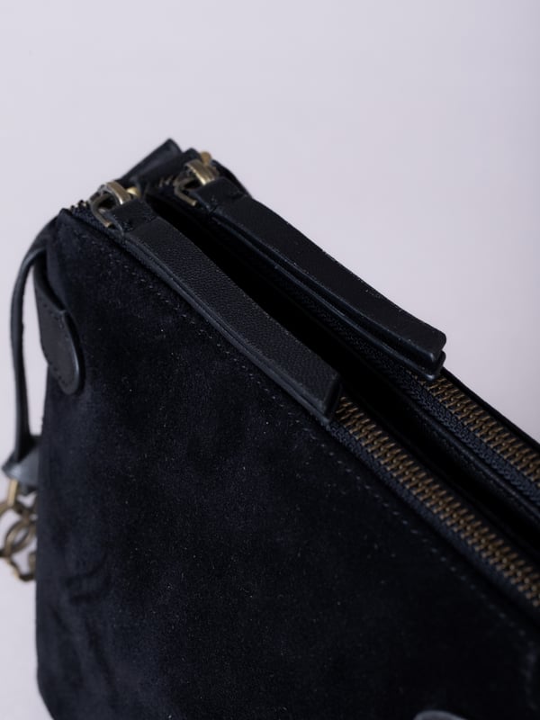 The Bridge twin cross body bag combines timeless style with practical design, making it a must-have for any wardrobe. Expertly crafted from real leather and suede, this versatile bag features a striking front suede compartment for added texture and interest. It also features an adjustable cross-body strap, offering a comfortable and customizable fit for hands-free wear.
With twin zip compartments &mdash; one smooth leather and one soft suede &mdash; there&rsquo;s ample space to keep essentials organized, while the interior slip pocket ensures smaller items stay secure. Finished with a ribbed fabric lining and available in three elegant colours, the Bridge bag is your go-to accessory for refined everyday style.