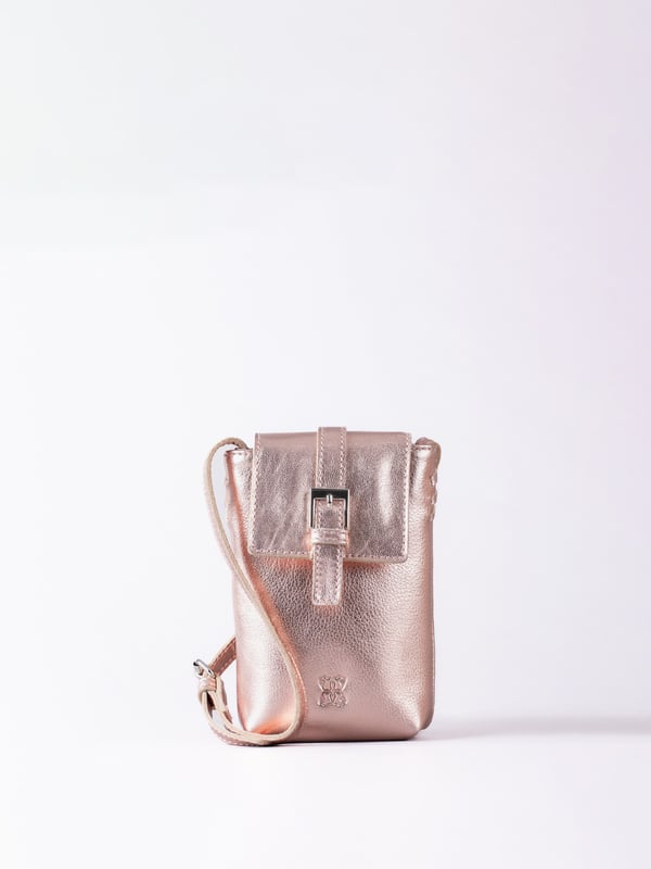 Small in size, big on style - the Tarnly phone pouch is the perfect hands-free companion for life on the move. Crafted from real leather with a soft satin lining, this compact cross-body features a flapover design secured with a magnetic press-stud fastening and finished with a decorative front buckle detail. Side stitch accents add a subtle crafted touch, while a rear zip pocket offers easy access to essentials. With an adjustable strap for the perfect fit, Tarnly keeps your phone and small valuables close in effortless style.