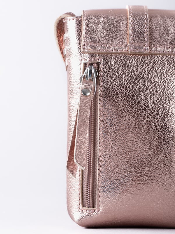 Small in size, big on style - the Tarnly phone pouch is the perfect hands-free companion for life on the move. Crafted from real leather with a soft satin lining, this compact cross-body features a flapover design secured with a magnetic press-stud fastening and finished with a decorative front buckle detail. Side stitch accents add a subtle crafted touch, while a rear zip pocket offers easy access to essentials. With an adjustable strap for the perfect fit, Tarnly keeps your phone and small valuables close in effortless style.