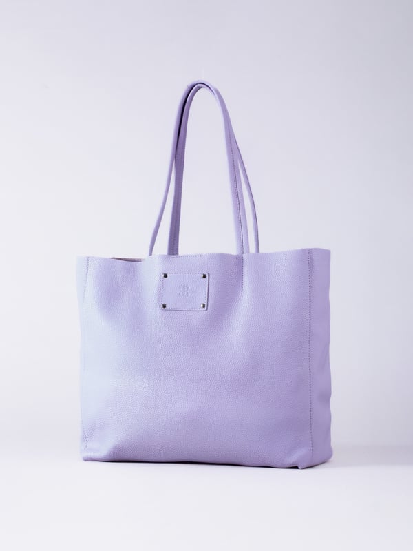 For relaxed leather luxury, look no further than the Tarn Bucket Bag in soft lilac. This spacious tote style bag will effortlessly take you through the working week into the weekend with plenty of room for a laptop and notebooks or shopping if you&rsquo;re hitting the high street.
Crafted from real leather in a contemporary slouchy design, this bucket bag is fitted with a popper fastened top and conceals a handy inner cloth bag with zip top opening to keep your valuables extra safe. This cloth bag is securely clipped to a leather strap and is removable for ultimate versatility.