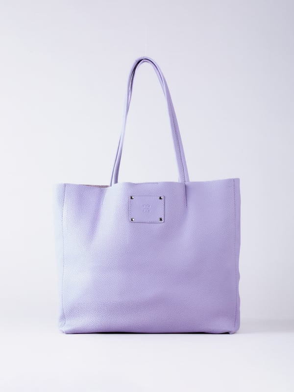 For relaxed leather luxury, look no further than the Tarn Bucket Bag in soft lilac. This spacious tote style bag will effortlessly take you through the working week into the weekend with plenty of room for a laptop and notebooks or shopping if you&rsquo;re hitting the high street.
Crafted from real leather in a contemporary slouchy design, this bucket bag is fitted with a popper fastened top and conceals a handy inner cloth bag with zip top opening to keep your valuables extra safe. This cloth bag is securely clipped to a leather strap and is removable for ultimate versatility.