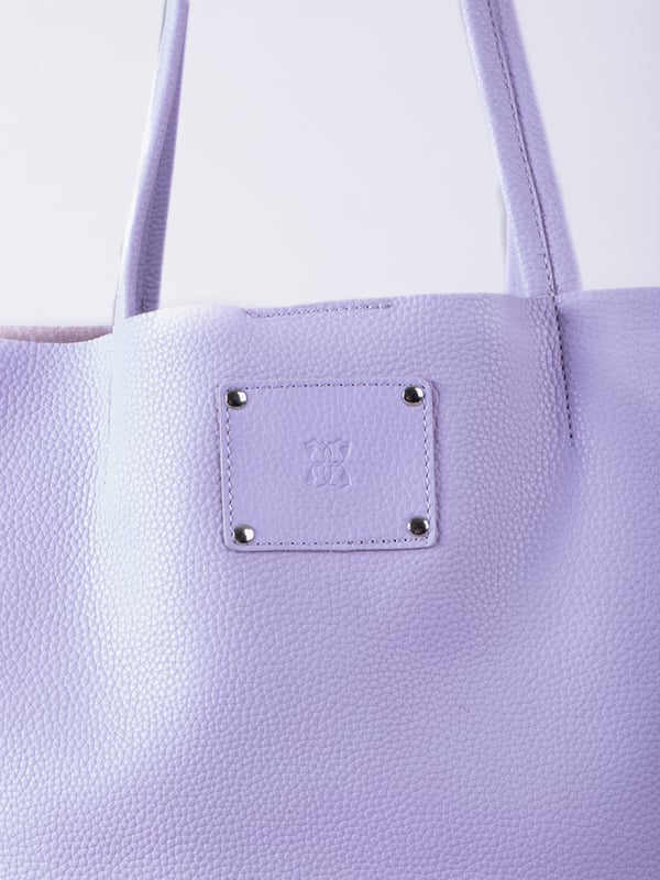 For relaxed leather luxury, look no further than the Tarn Bucket Bag in soft lilac. This spacious tote style bag will effortlessly take you through the working week into the weekend with plenty of room for a laptop and notebooks or shopping if you&rsquo;re hitting the high street.
Crafted from real leather in a contemporary slouchy design, this bucket bag is fitted with a popper fastened top and conceals a handy inner cloth bag with zip top opening to keep your valuables extra safe. This cloth bag is securely clipped to a leather strap and is removable for ultimate versatility.