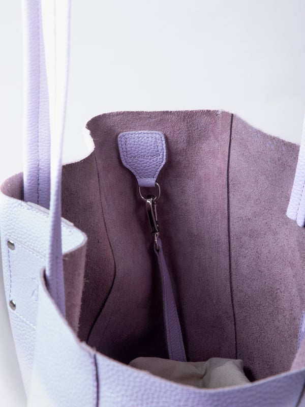 For relaxed leather luxury, look no further than the Tarn Bucket Bag in soft lilac. This spacious tote style bag will effortlessly take you through the working week into the weekend with plenty of room for a laptop and notebooks or shopping if you&rsquo;re hitting the high street.
Crafted from real leather in a contemporary slouchy design, this bucket bag is fitted with a popper fastened top and conceals a handy inner cloth bag with zip top opening to keep your valuables extra safe. This cloth bag is securely clipped to a leather strap and is removable for ultimate versatility.