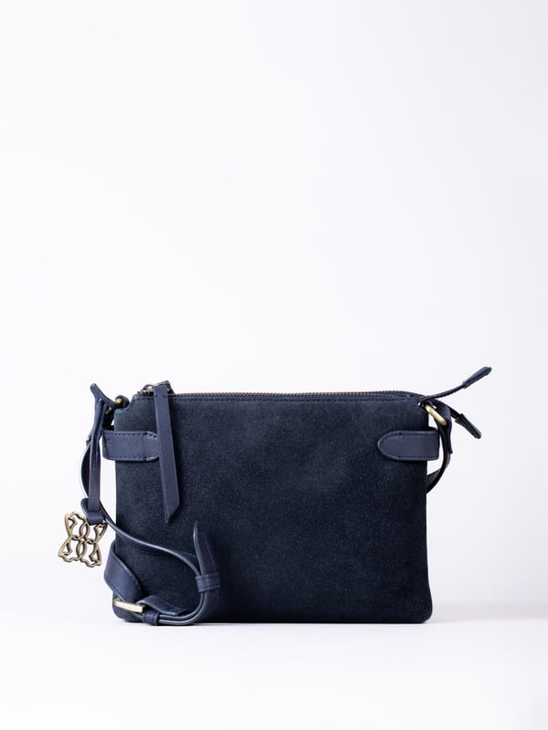 The Bridge twin cross body bag combines timeless style with practical design, making it a must-have for any wardrobe. Expertly crafted from real leather and suede, this versatile bag features a striking front suede compartment for added texture and interest. It also features an adjustable cross-body strap, offering a comfortable and customizable fit for hands-free wear.
With twin zip compartments &mdash; one smooth leather and one soft suede &mdash; there&rsquo;s ample space to keep essentials organized, while the interior slip pocket ensures smaller items stay secure. Finished with a ribbed fabric lining and available in three elegant colours, the Bridge bag is your go-to accessory for refined everyday style.