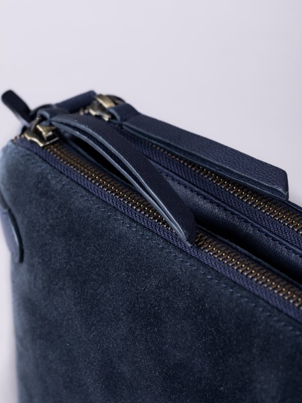The Bridge twin cross body bag combines timeless style with practical design, making it a must-have for any wardrobe. Expertly crafted from real leather and suede, this versatile bag features a striking front suede compartment for added texture and interest. It also features an adjustable cross-body strap, offering a comfortable and customizable fit for hands-free wear.
With twin zip compartments &mdash; one smooth leather and one soft suede &mdash; there&rsquo;s ample space to keep essentials organized, while the interior slip pocket ensures smaller items stay secure. Finished with a ribbed fabric lining and available in three elegant colours, the Bridge bag is your go-to accessory for refined everyday style.