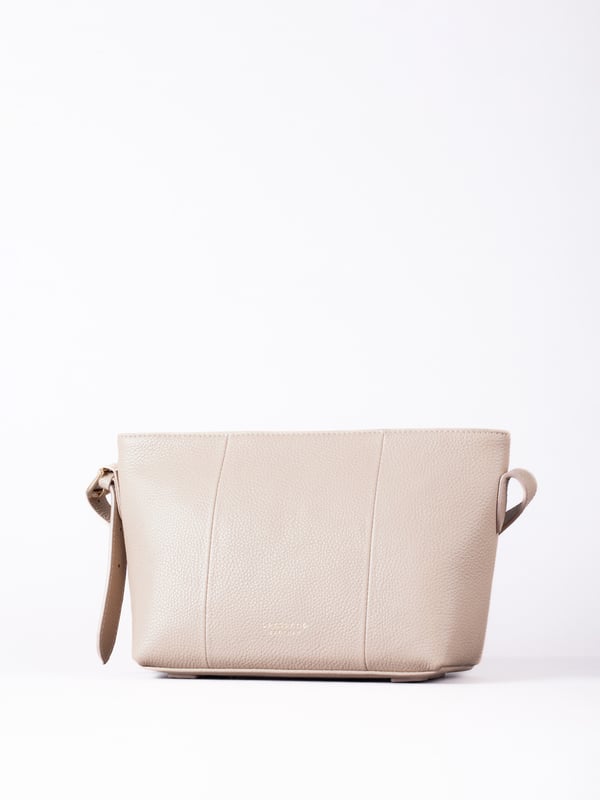 The Langdale cross body is the epitome of sleek sophistication, combining minimalist design with everyday practicality.
Crafted from supple real leather, this compact yet spacious bag boasts a clean silhouette that enhances its refined appeal. The adjustable cross-body strap offers effortless versatility, while the zip-top closure keeps your belongings secure.
Thoughtfully designed, it features a rear slip pocket and interior zip and slip pockets to keep essentials organized. Accentuated with gold-tone hardware and subtle foil branding, the Langdale is lined with ribbed fabric for an added touch of elegance.
Perfect for complementing both casual and formal looks, this bag is a timeless addition to your wardrobe.