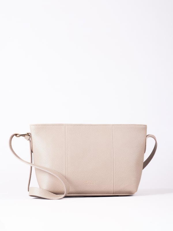 The Langdale cross body is the epitome of sleek sophistication, combining minimalist design with everyday practicality.
Crafted from supple real leather, this compact yet spacious bag boasts a clean silhouette that enhances its refined appeal. The adjustable cross-body strap offers effortless versatility, while the zip-top closure keeps your belongings secure.
Thoughtfully designed, it features a rear slip pocket and interior zip and slip pockets to keep essentials organized. Accentuated with gold-tone hardware and subtle foil branding, the Langdale is lined with ribbed fabric for an added touch of elegance.
Perfect for complementing both casual and formal looks, this bag is a timeless addition to your wardrobe.