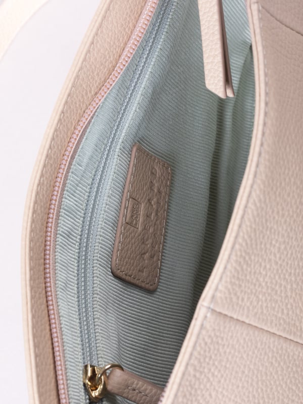 The Langdale cross body is the epitome of sleek sophistication, combining minimalist design with everyday practicality.
Crafted from supple real leather, this compact yet spacious bag boasts a clean silhouette that enhances its refined appeal. The adjustable cross-body strap offers effortless versatility, while the zip-top closure keeps your belongings secure.
Thoughtfully designed, it features a rear slip pocket and interior zip and slip pockets to keep essentials organized. Accentuated with gold-tone hardware and subtle foil branding, the Langdale is lined with ribbed fabric for an added touch of elegance.
Perfect for complementing both casual and formal looks, this bag is a timeless addition to your wardrobe.
